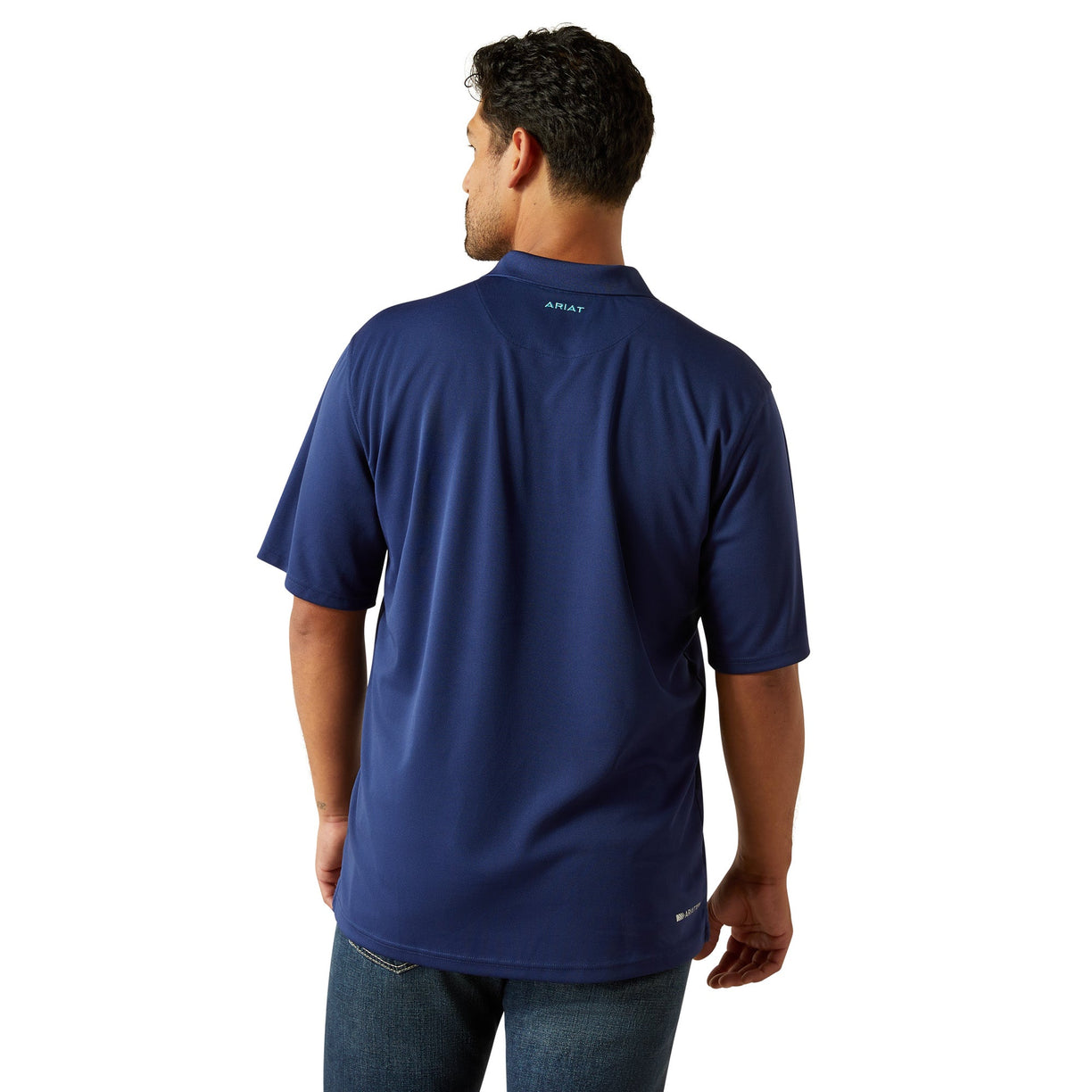 Man wearing a blue shirt with a brand logo on the back, standing against a white background